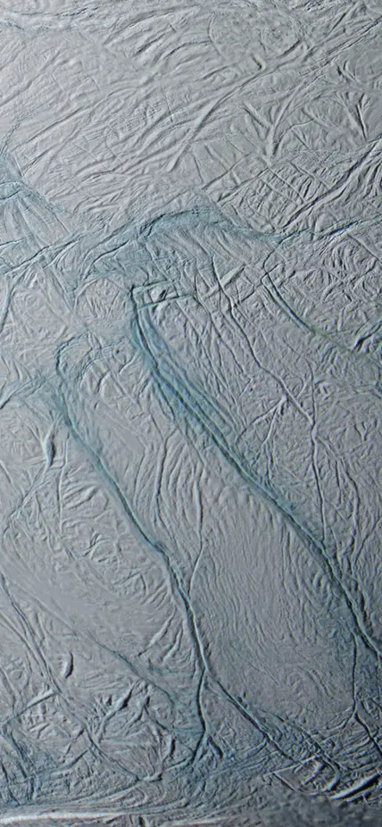 An enhanced color image of the south pole of Saturn’s moon, Enceladus, with the five parallel fissures in the surface, named the Tiger Stripes, clearly visible. This image is a mosaic of 21 false-color frames taken during the Cassini spacecraft’s close fly-by mission on March 9 and July 14, 2005. Image credit: NASA/JPL/Space Science Institute