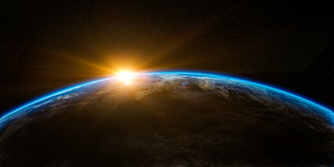 The sun shines on the horizon of Earth, as viewed from space. 