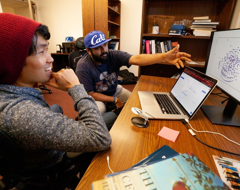 Mike Wong and colleague Anirudh Prabhu discuss how to tweak the presentation of a network of Earth's atmospheric chemistry in their shared office on the Broad Branch Road campus. 